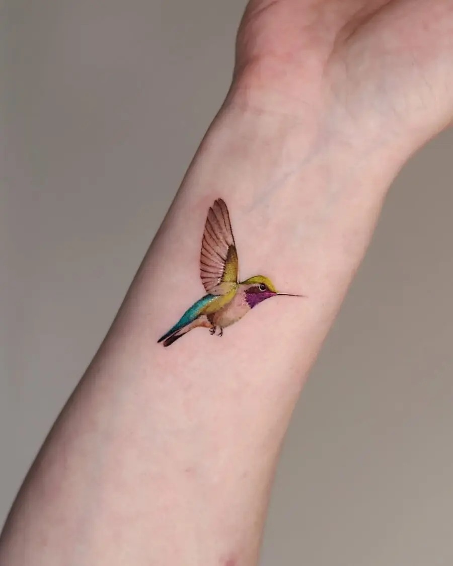 Vibrant hummingbird tattoo on the arm