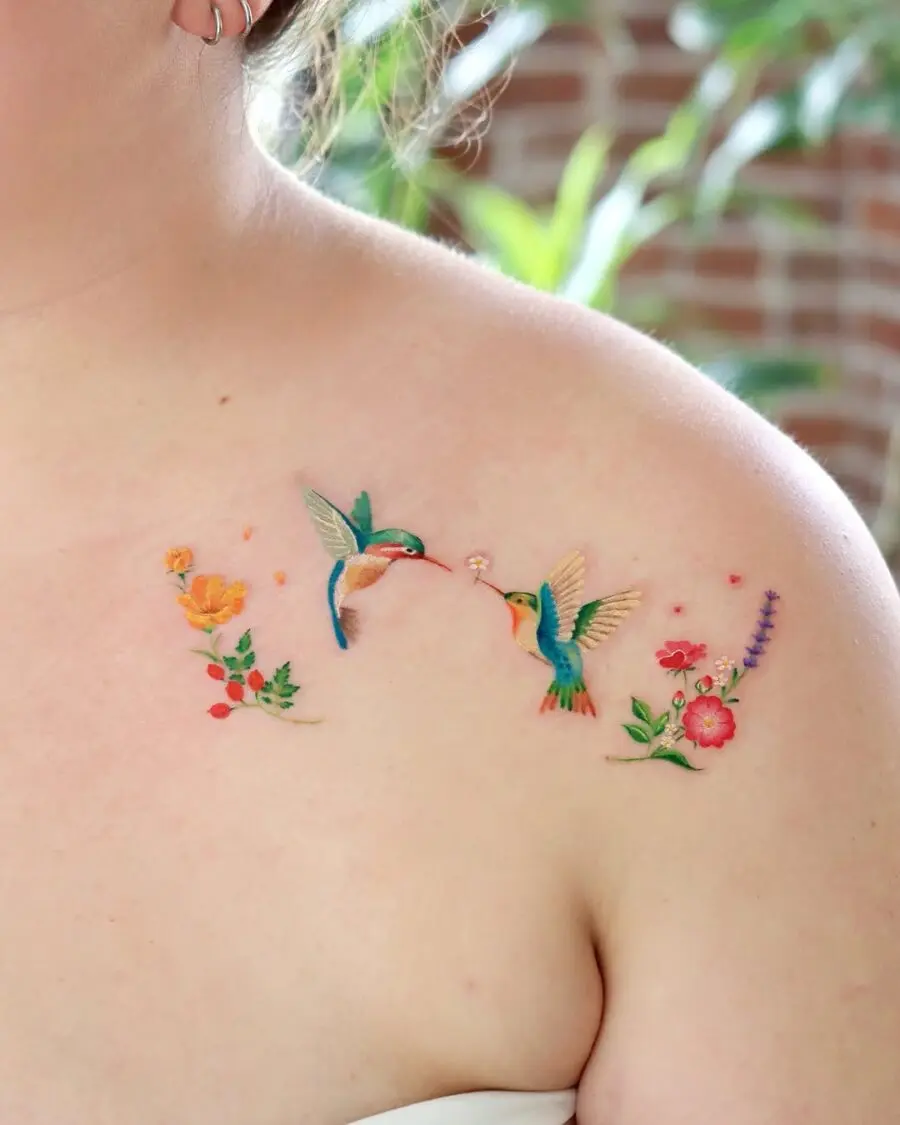 Vivid hummingbird tattoo with floral embellishments