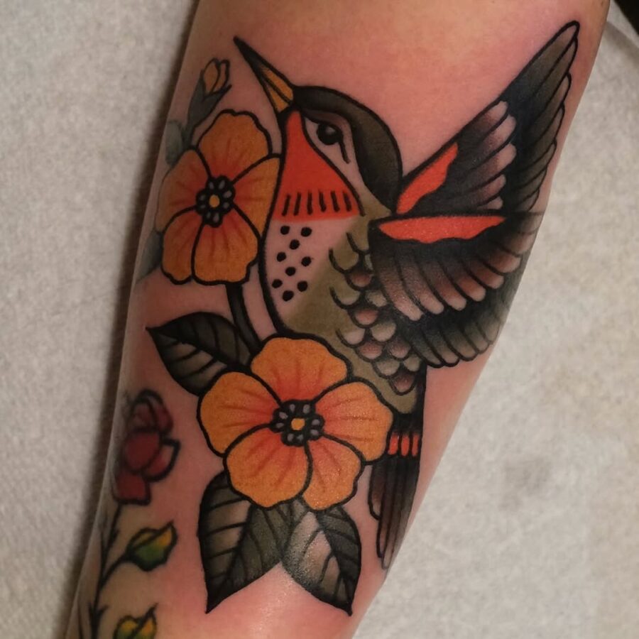 Vibrant hummingbird tattoo with floral elements