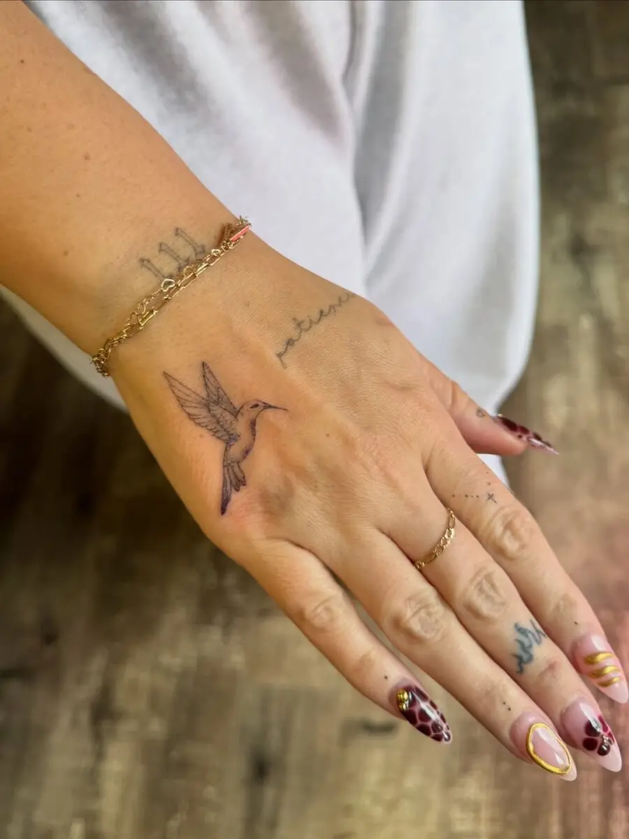 Delicate Hummingbird Tattoo on Hand