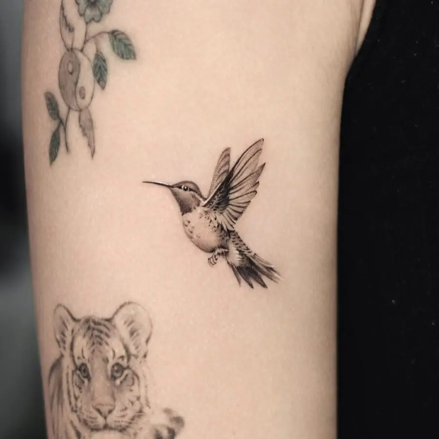 Delicate hummingbird tattoo with intricate details