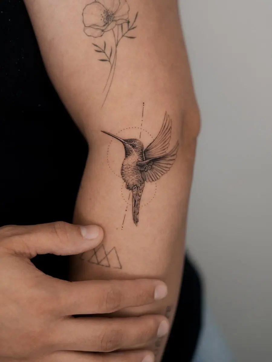 Delicate hummingbird tattoo captures graceful essence