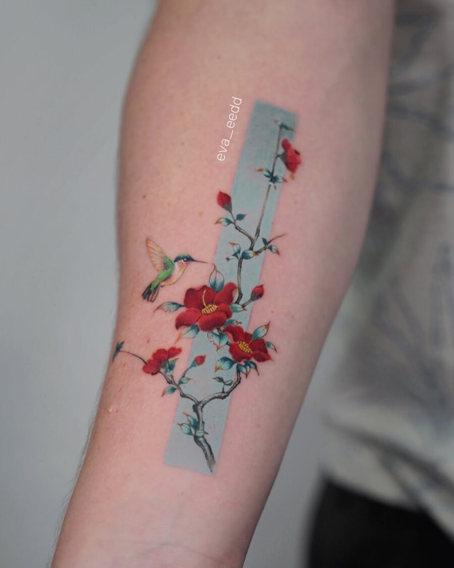 Vibrant hummingbird with blossoming flowers tattoo