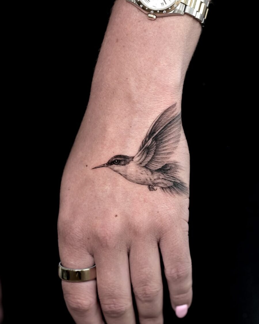 Elegant hummingbird tattoo in dynamic flight