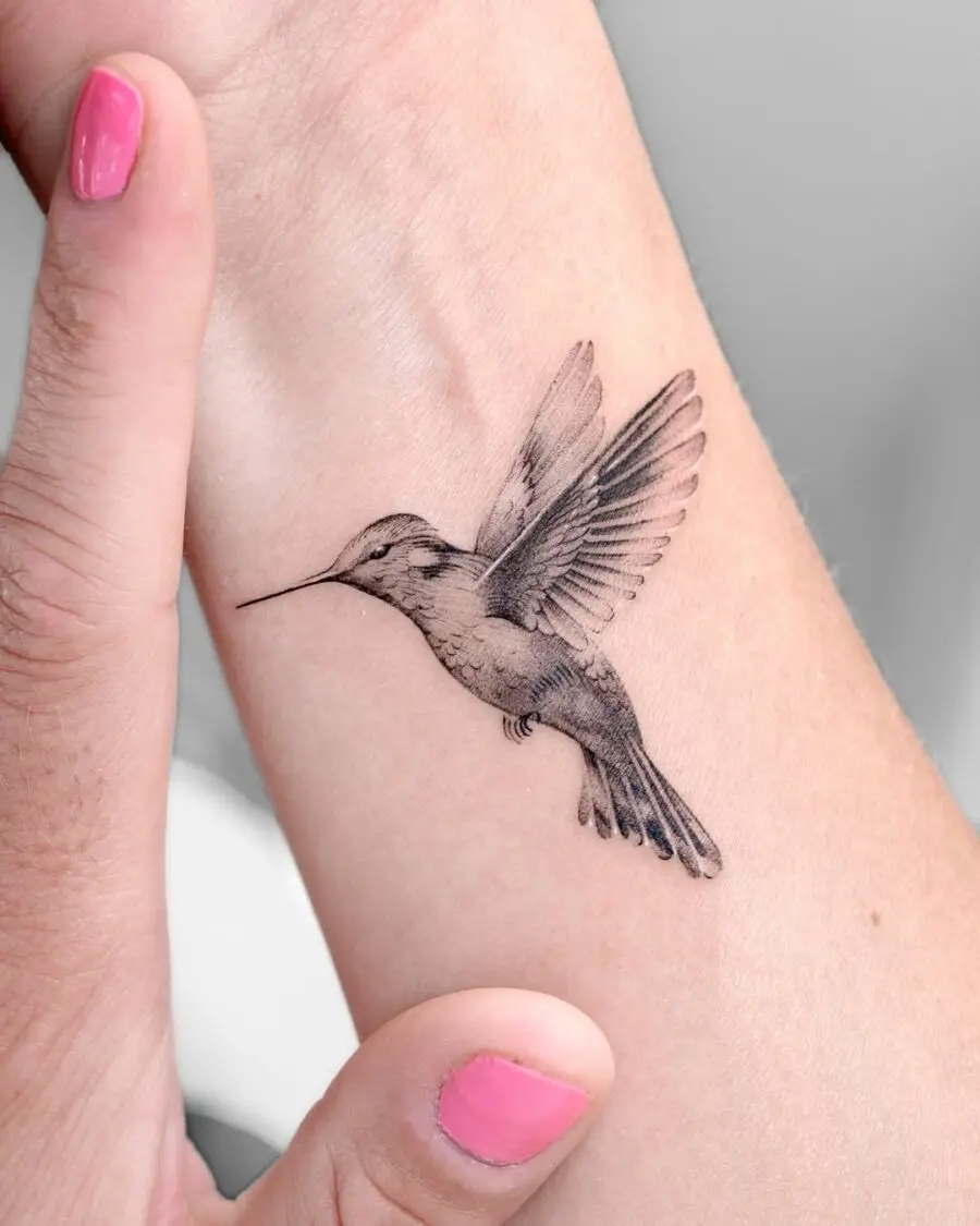 Realistic hummingbird tattoo design on arm