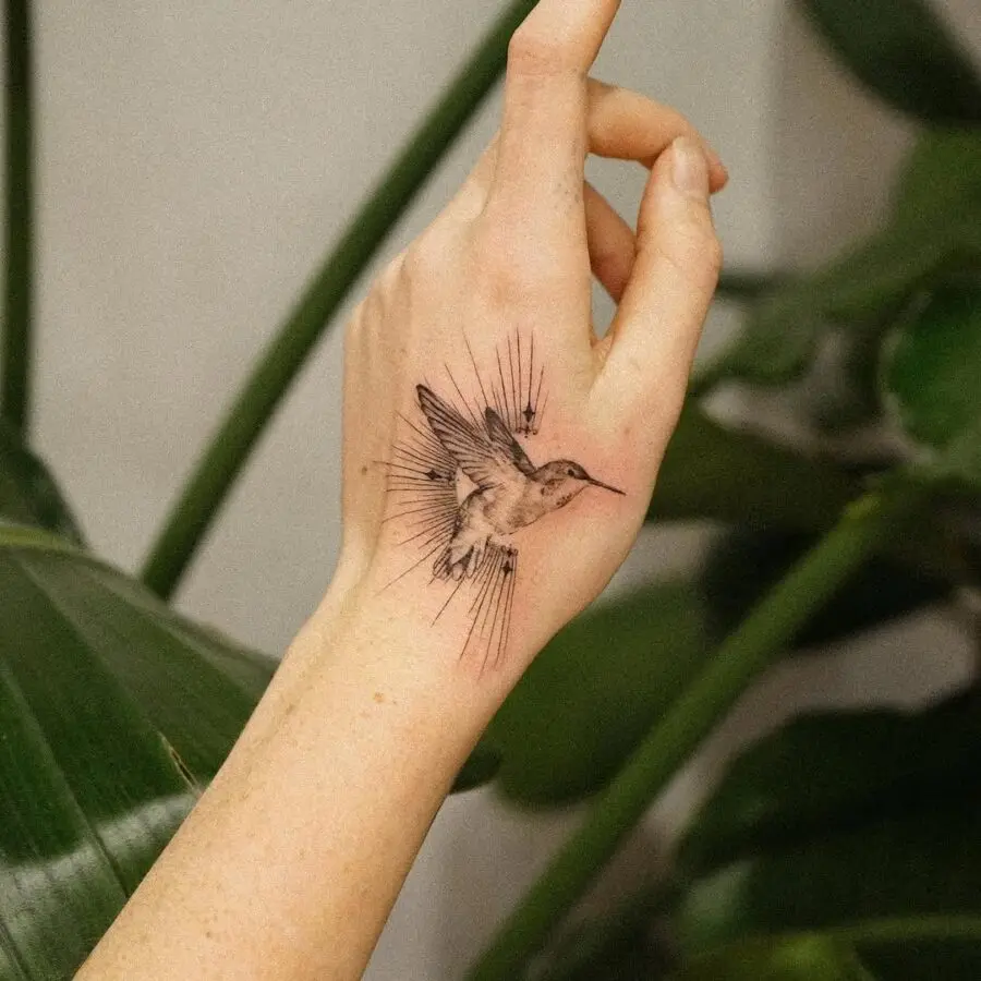 Elegant hummingbird tattoo on a hand