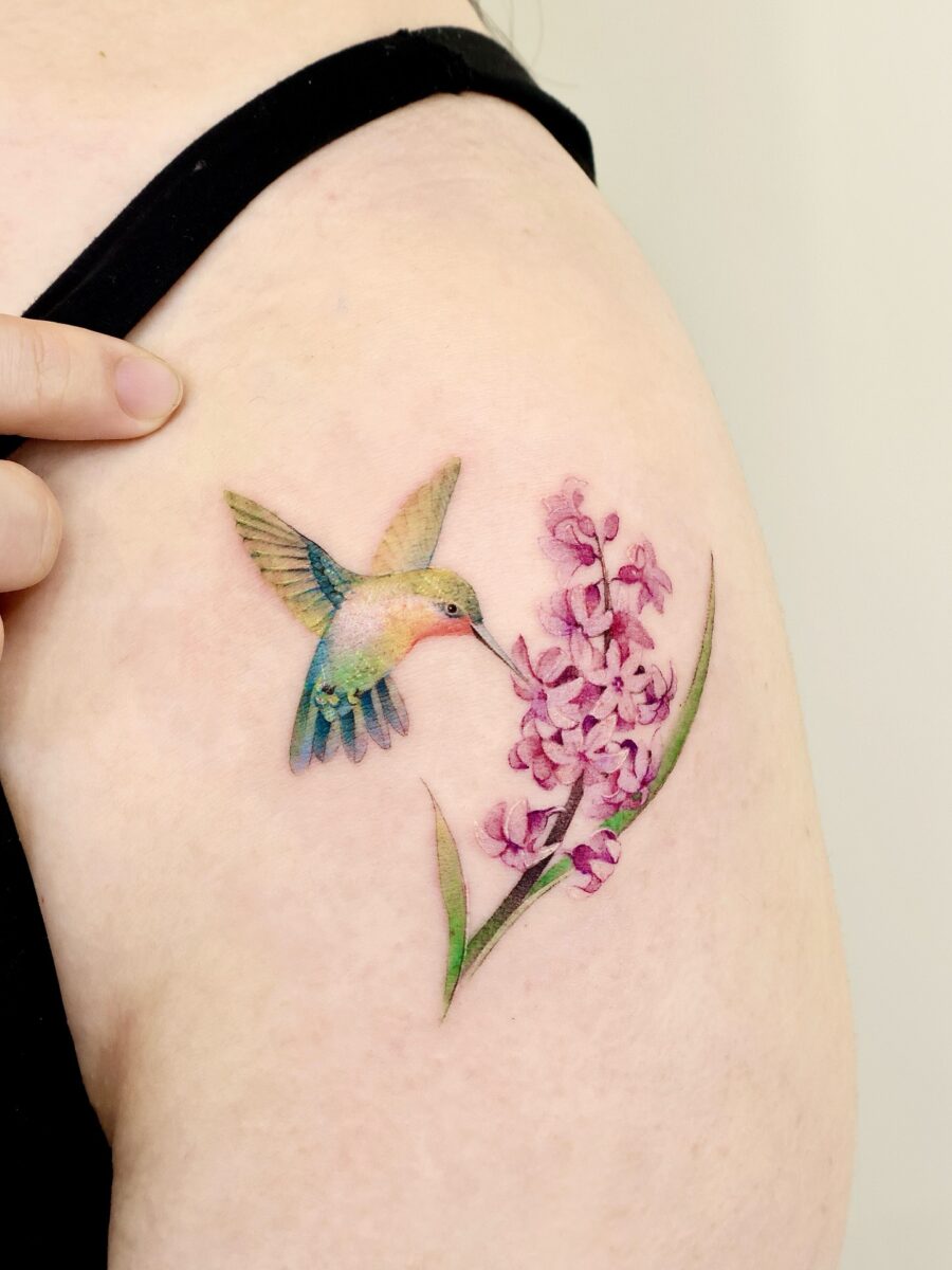 Vibrant Hummingbird and Orchid Tattoo Art