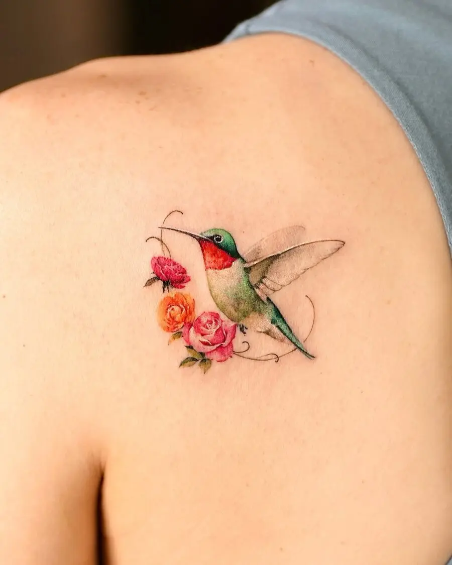 Intricate hummingbird tattoo with blooming roses