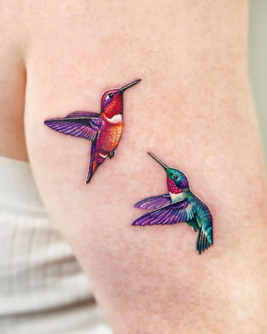 Vividly colored hummingbird tattoos on arm