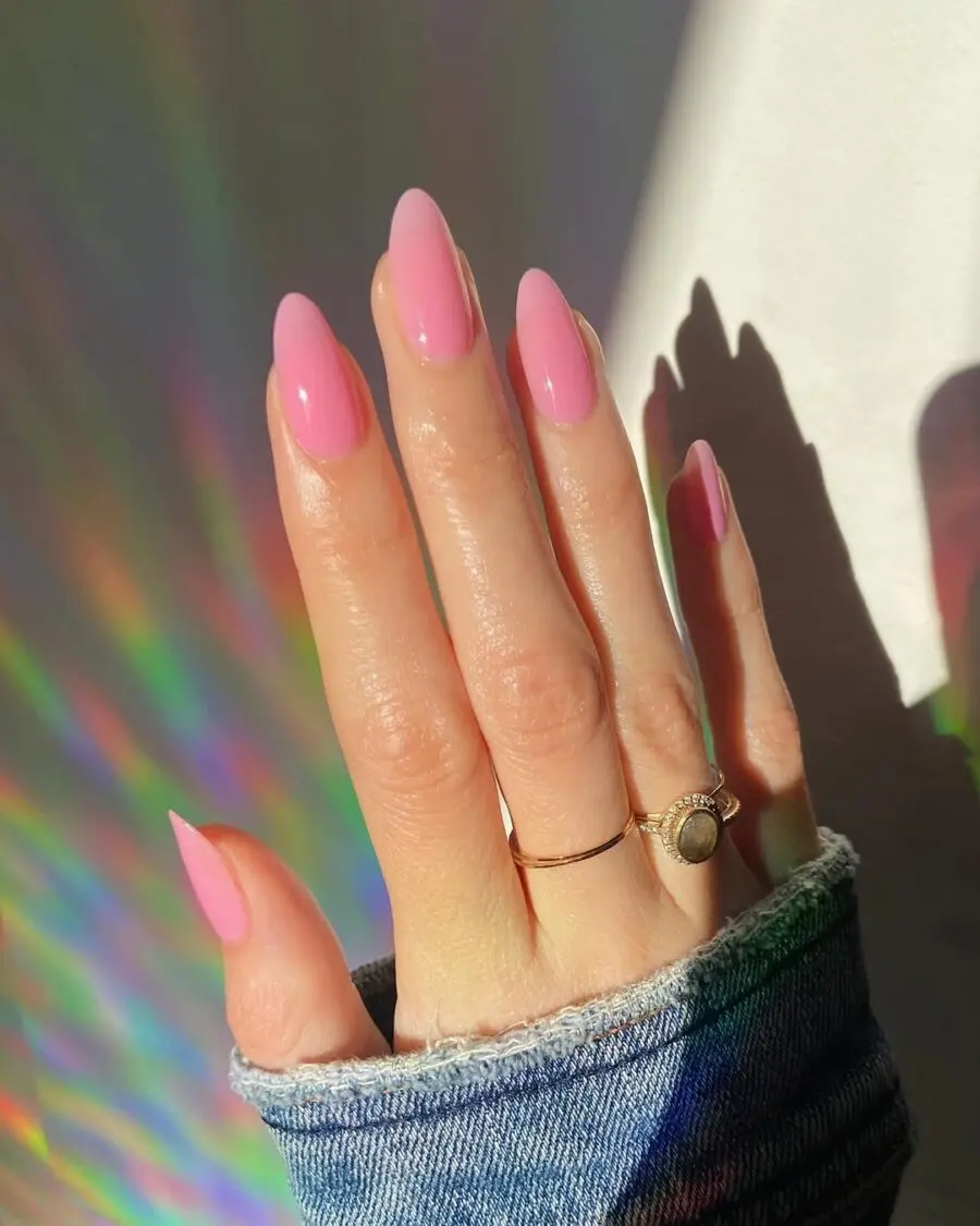 Vibrant pink jelly nails with rainbow hues