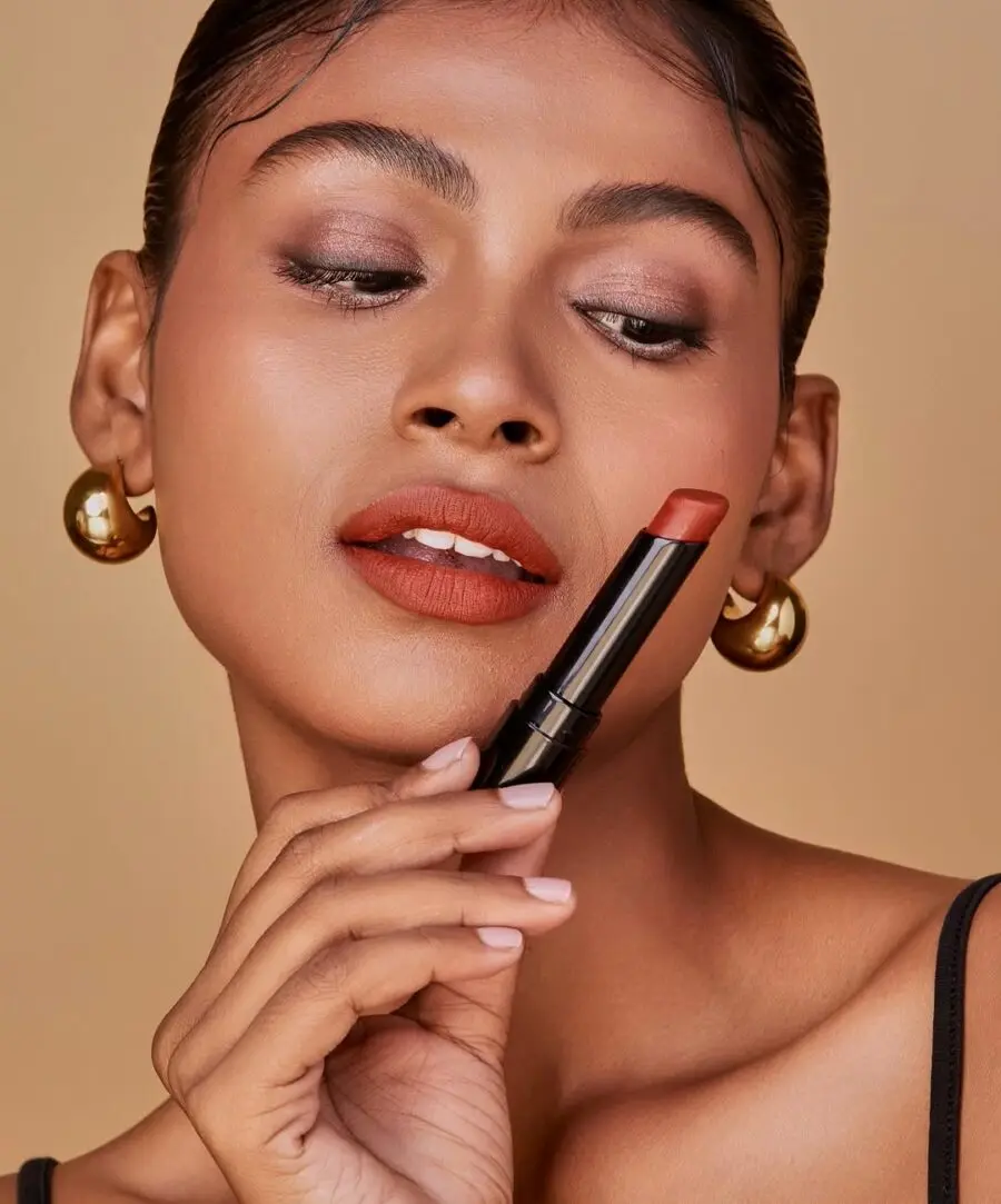 Rich terracotta shade enhances dark skin tones.