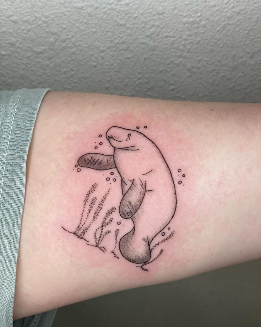Charming Manatee Tattoo with Underwater Elements