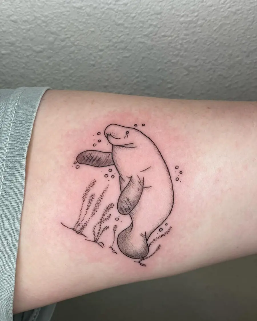 Charming Manatee Tattoo with Underwater Elements