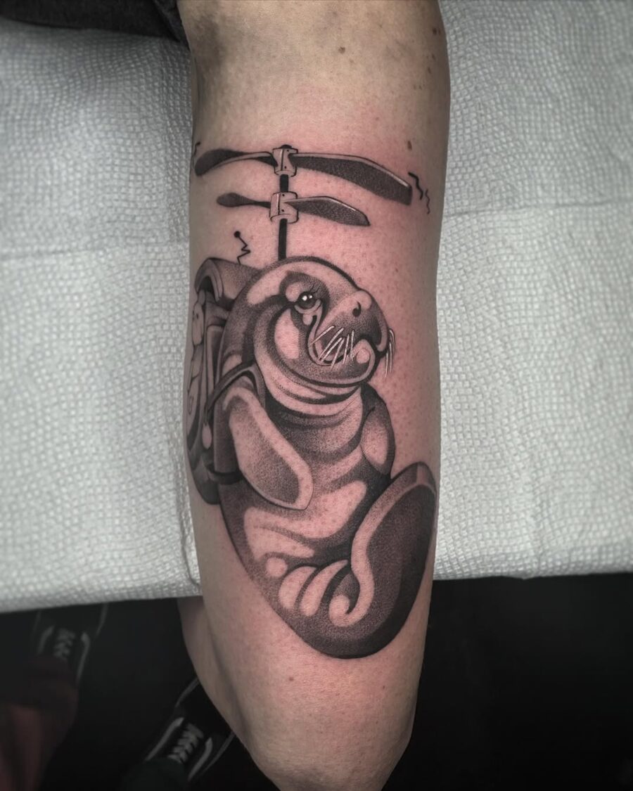 Charming manatee tattoo with a playful vibe