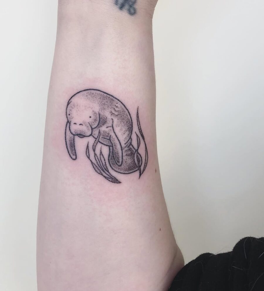 Uniquely styled manatee tattoo in black ink