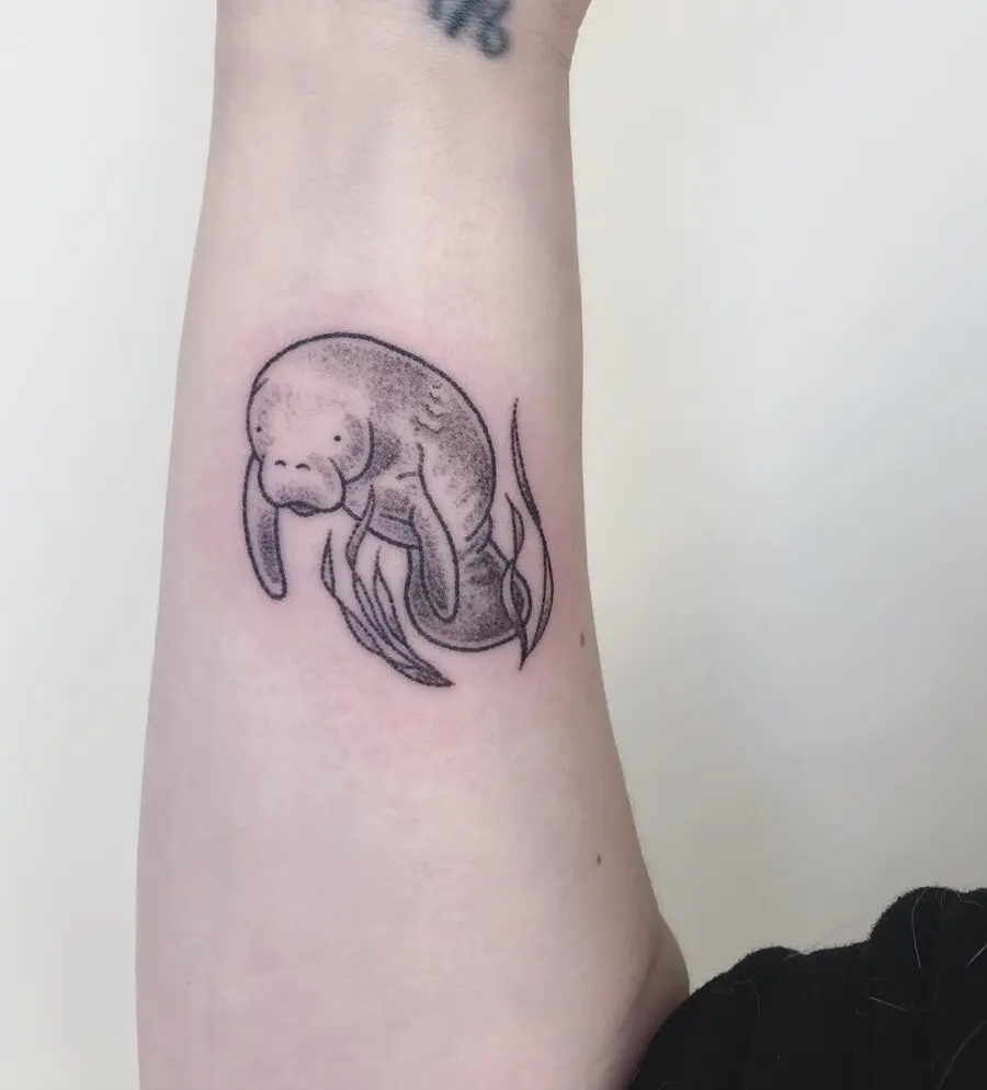 Uniquely styled manatee tattoo in black ink