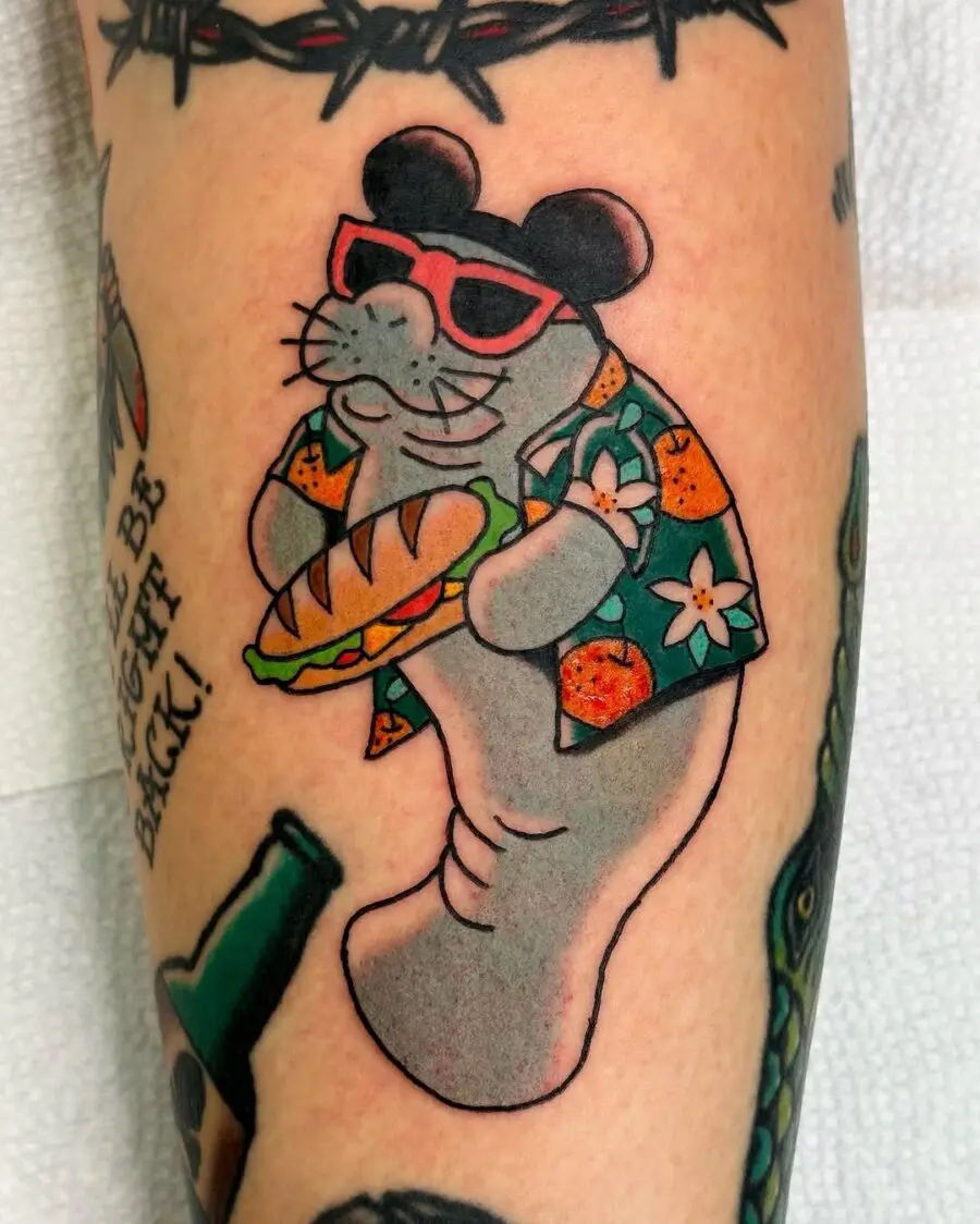Playful manatee tattoo in Hawaiian shirt