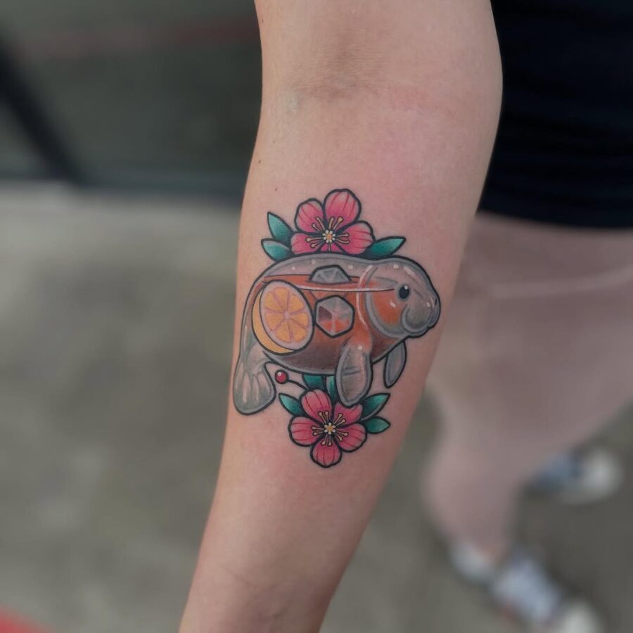 Playful manatee tattoo with citrus accents