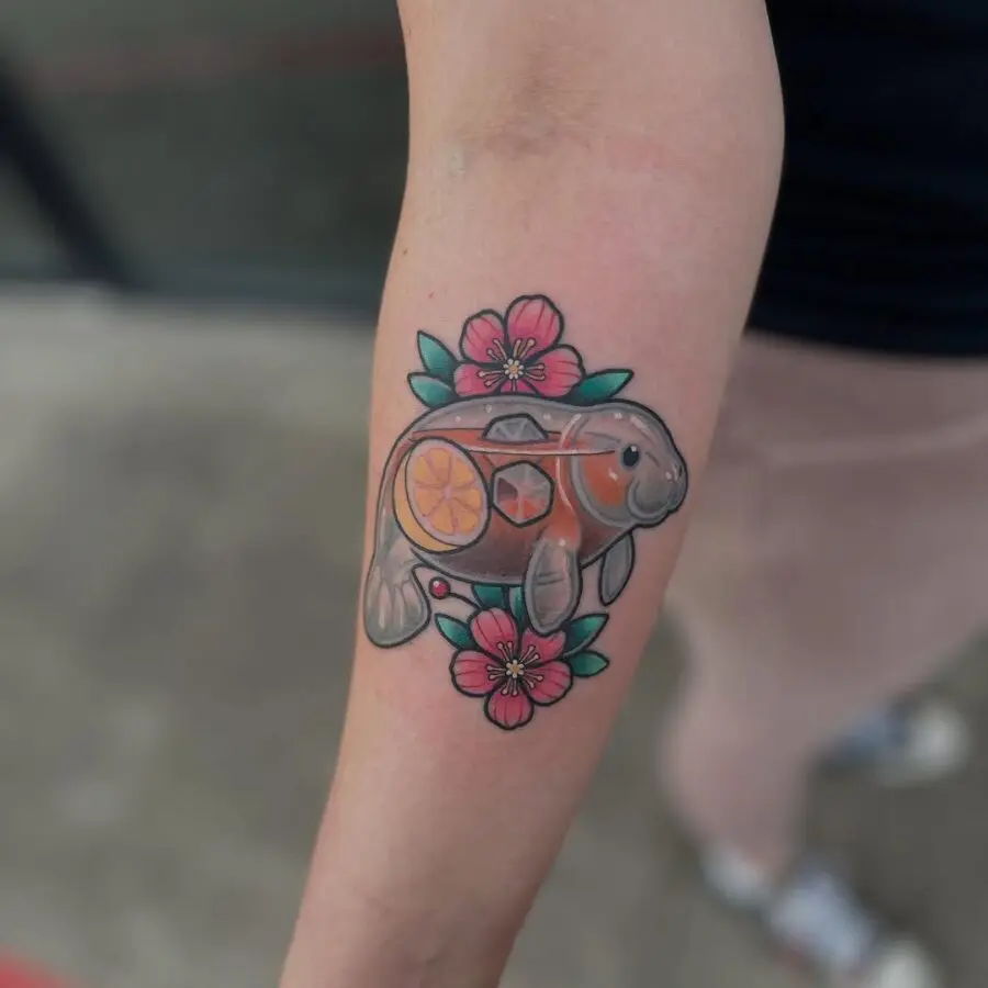 Playful manatee tattoo with citrus accents