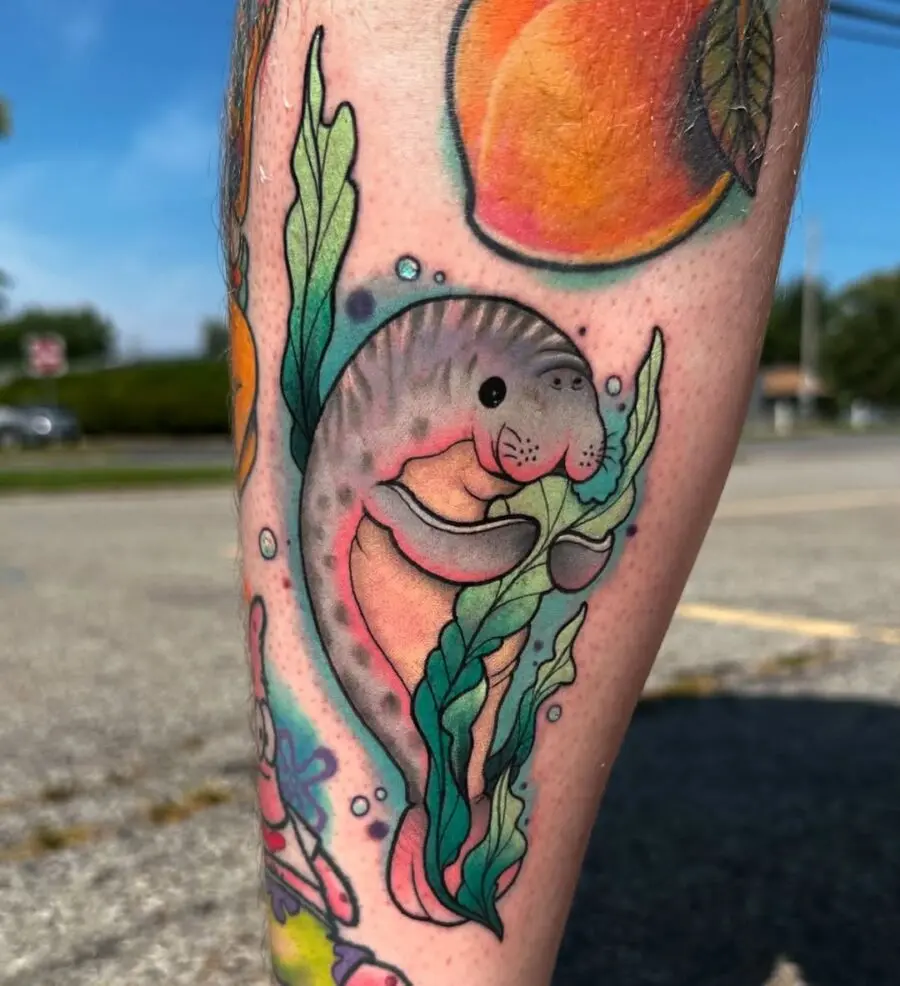 Charming manatee tattoo with seaweed detail
