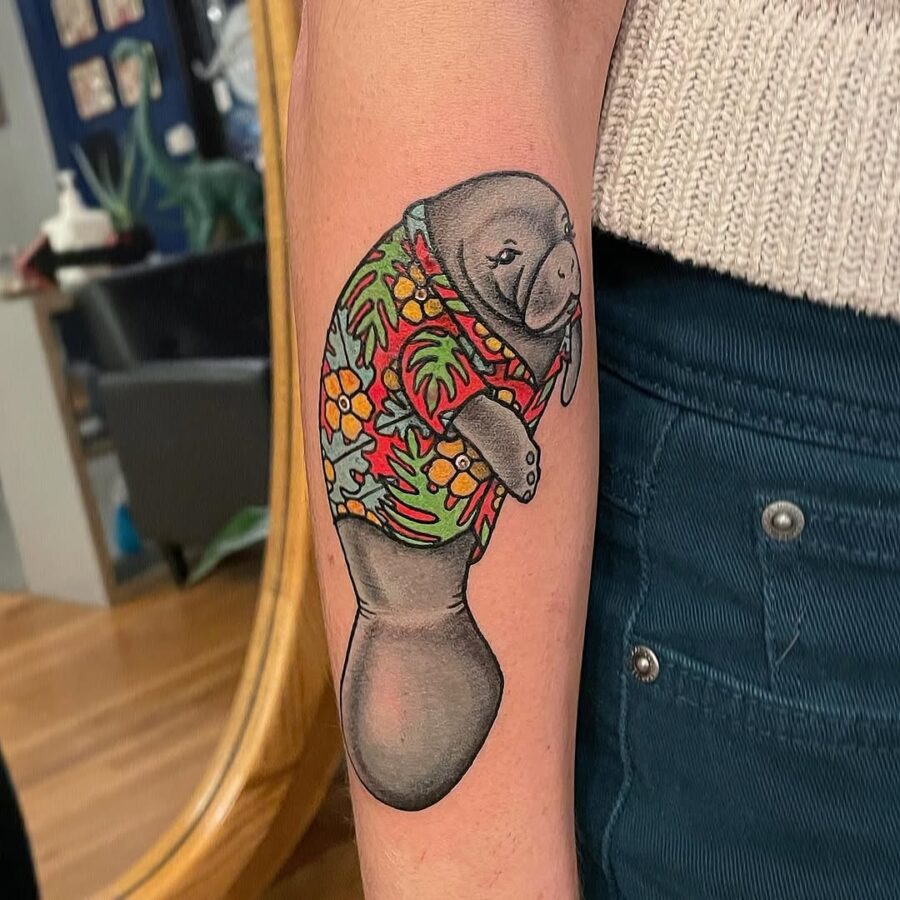 Playful manatee in colorful Hawaiian shirt tattoo