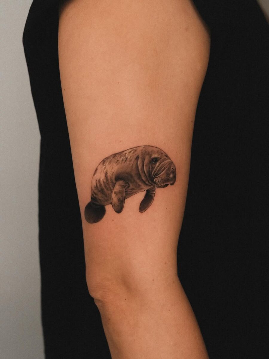 Delicate Manatee Tattoo on Arm