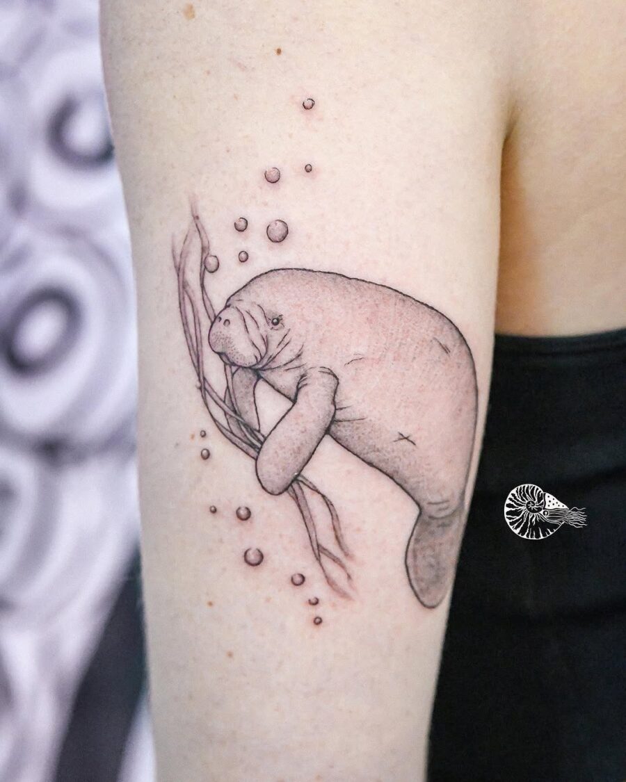 Whimsical manatee tattoo showcasing aquatic charm