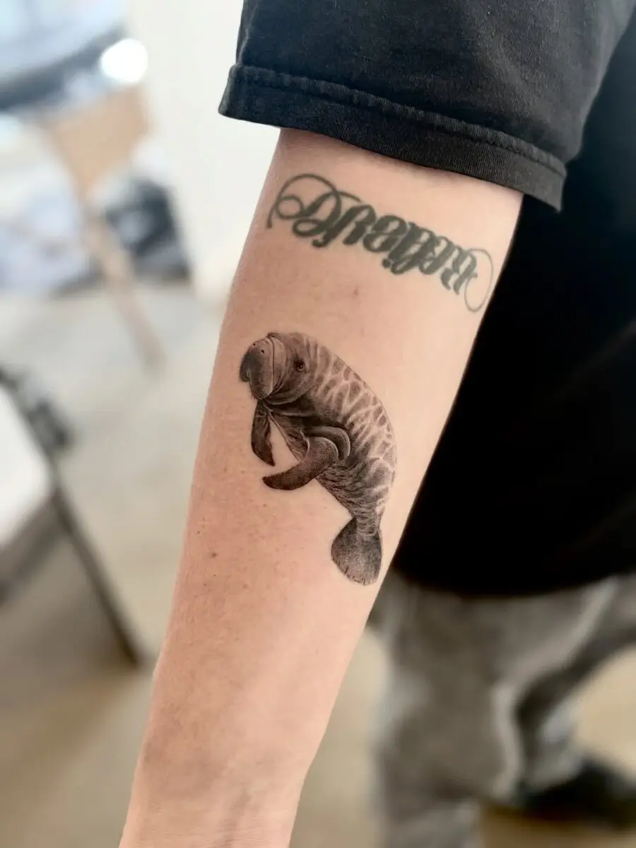 Elegant manatee tattoo showcasing unique artistry