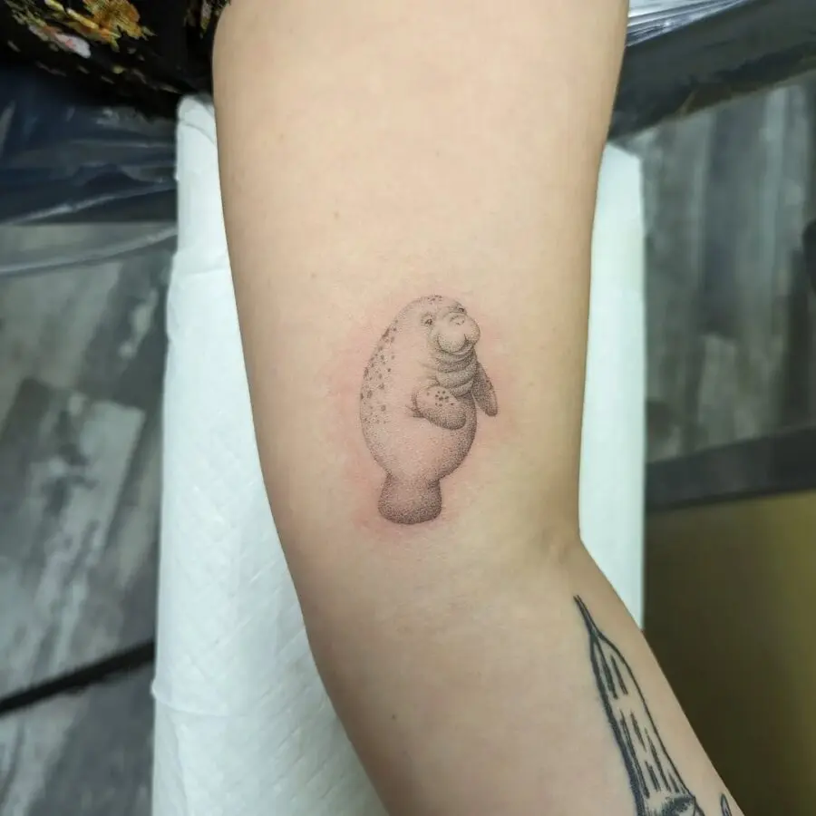 Charming manatee tattoo brings playful vibes.