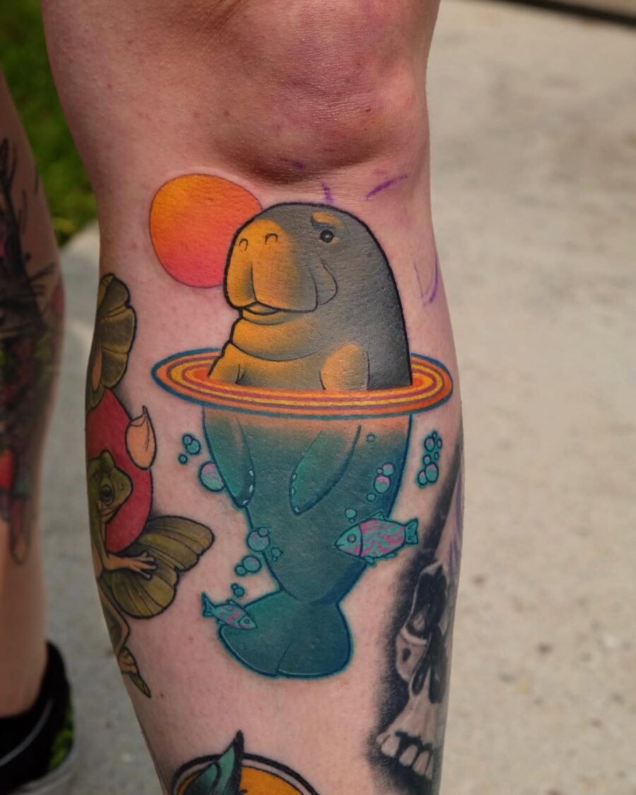 Playful manatee tattoo with vivid colors