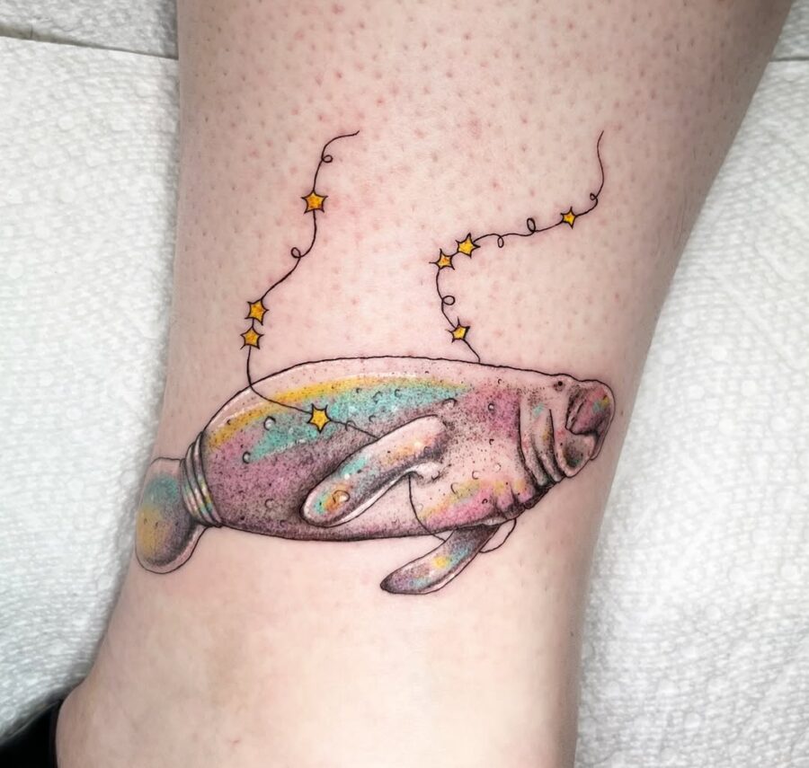 Whimsical manatee tattoo with magical starry vibe