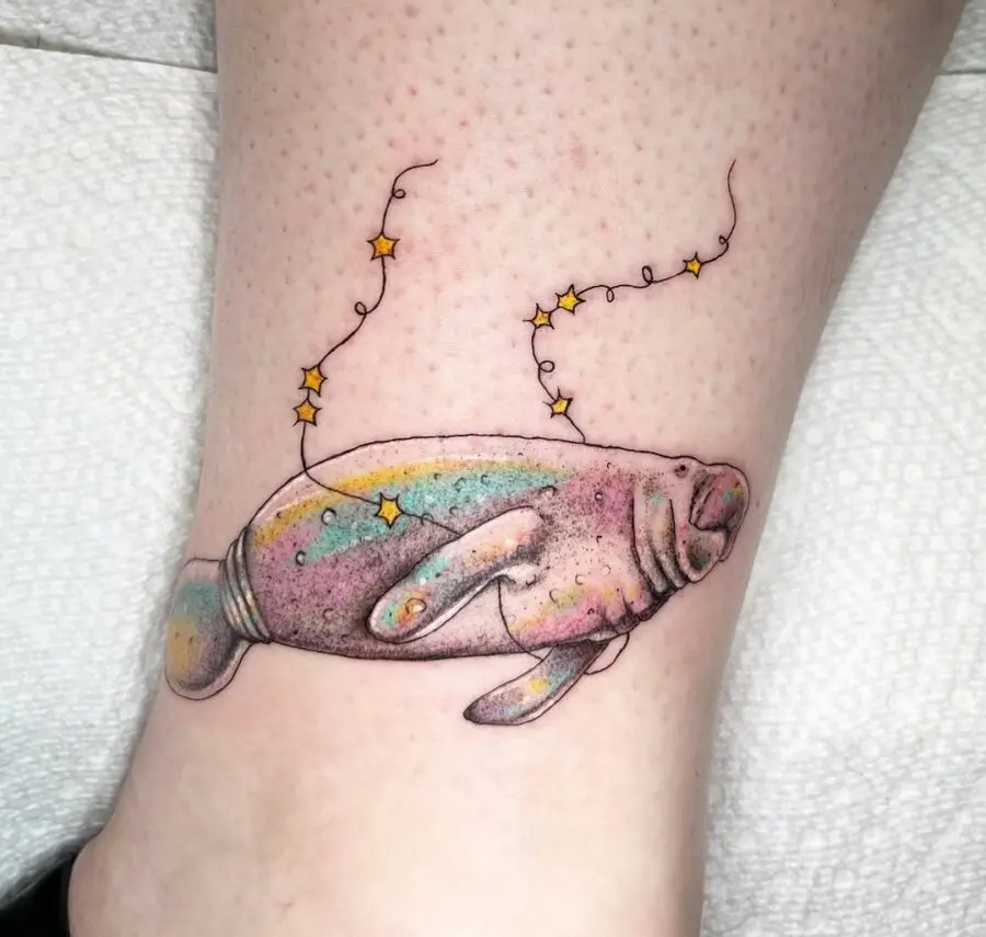 Whimsical manatee tattoo with magical starry vibe