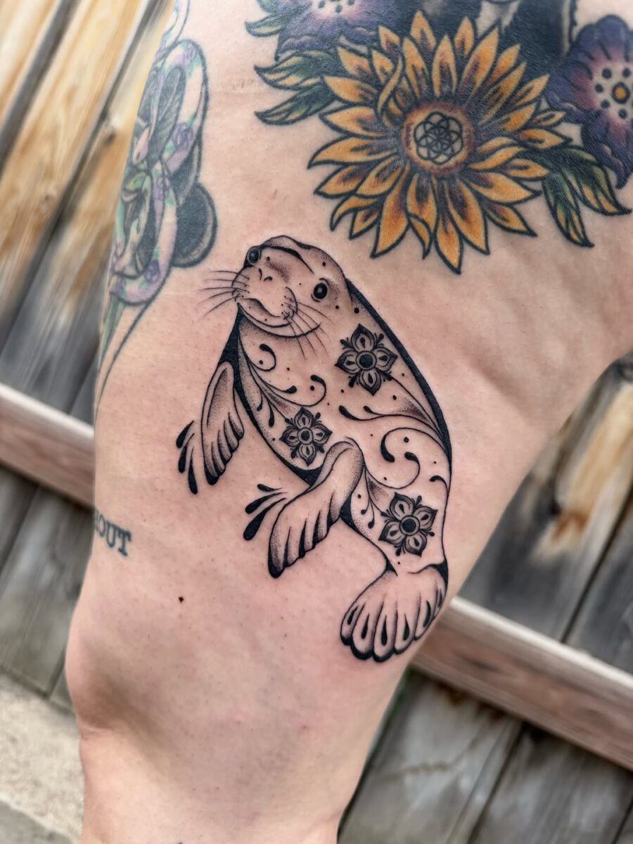 Charming Manatee Tattoo with Floral Designs