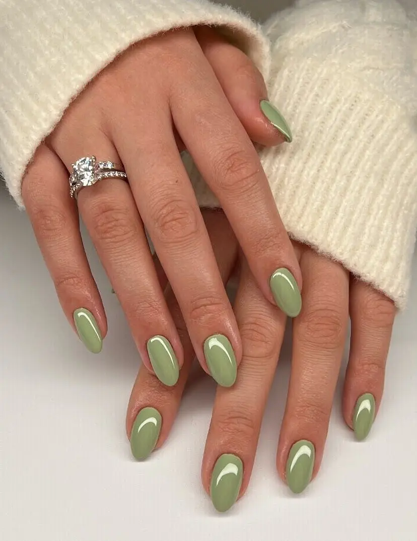 Stylish matcha green oval nails with white accents