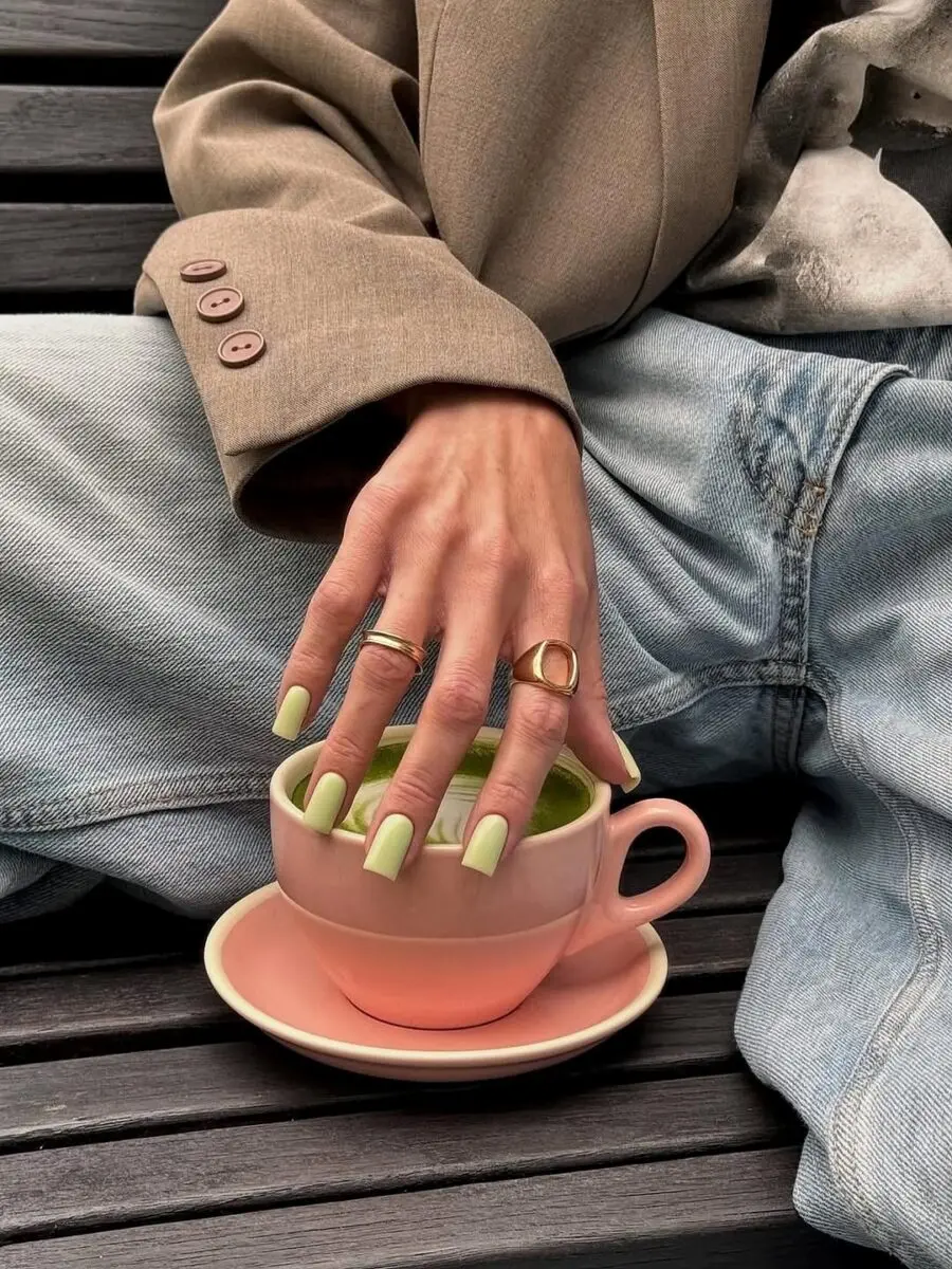 Stylish matcha-inspired green nails in hand