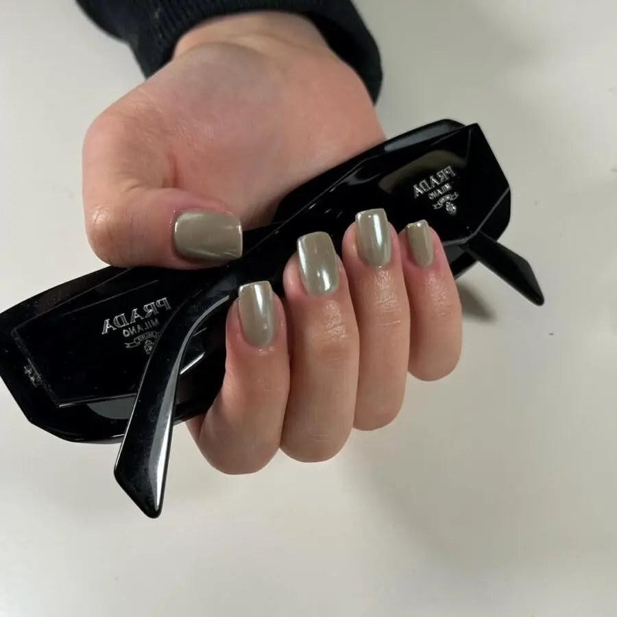 Trendy matcha nails with sleek sunglasses