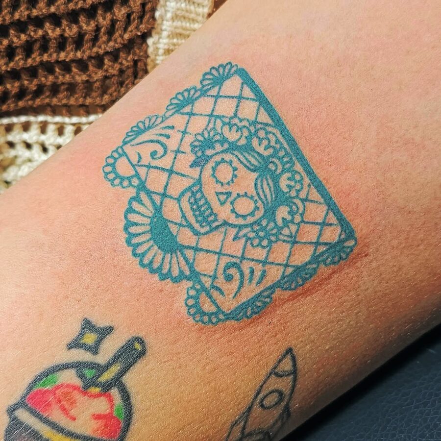 Intricate sugar skull tattoo with lace details