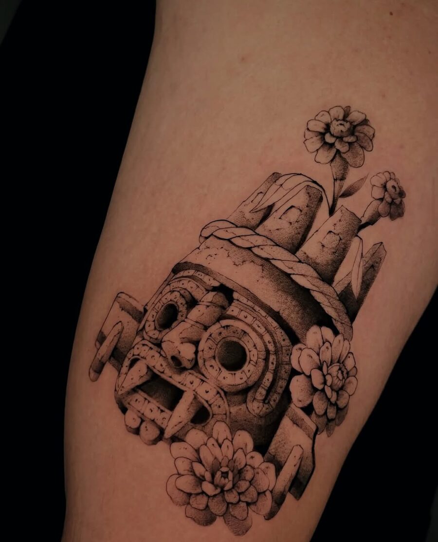 Intricate Aztec skull tattoo design with flowers