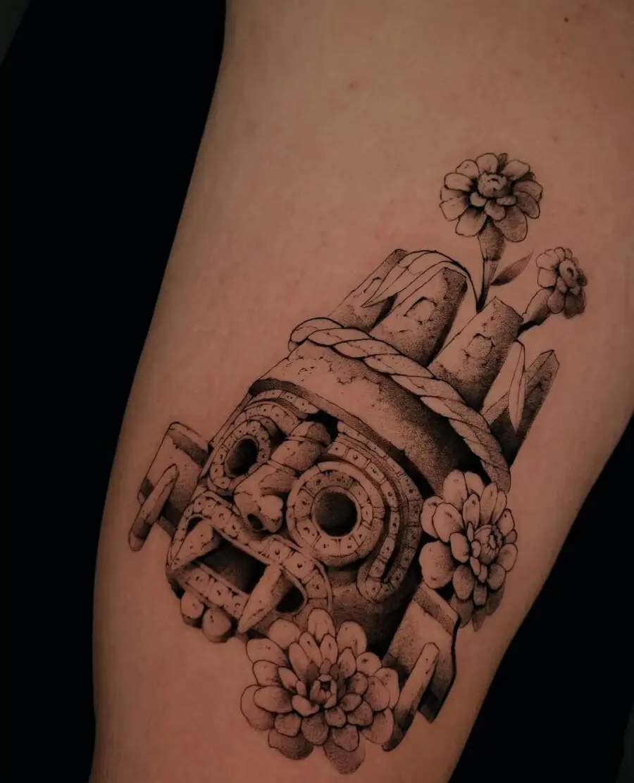 Intricate Aztec skull tattoo design with flowers