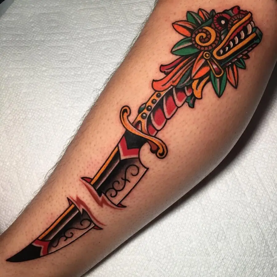Vibrant dagger tattoo with floral elements