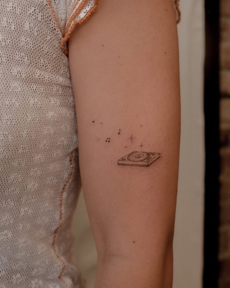 Charming record player tattoo with musical notes