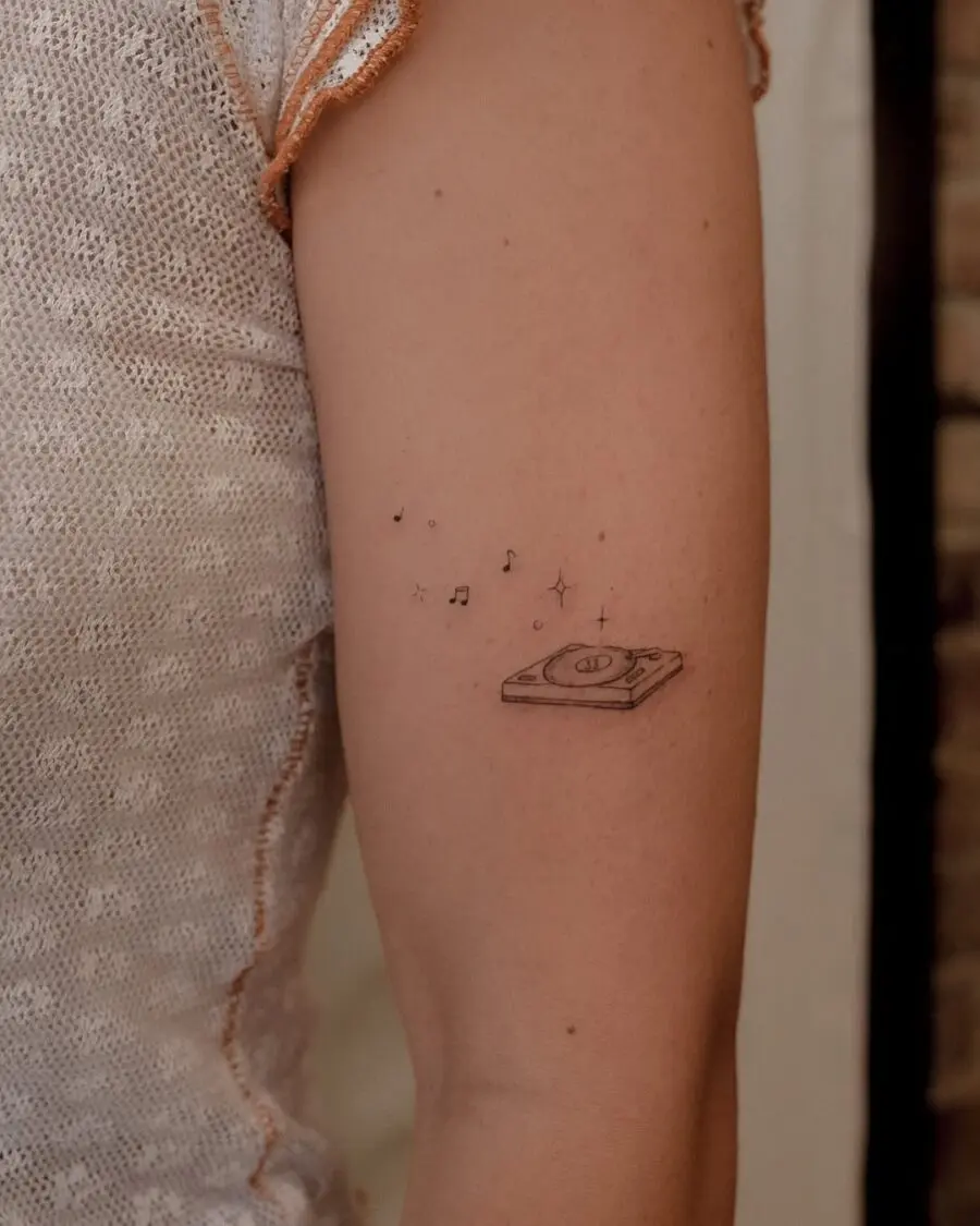 Charming record player tattoo with musical notes