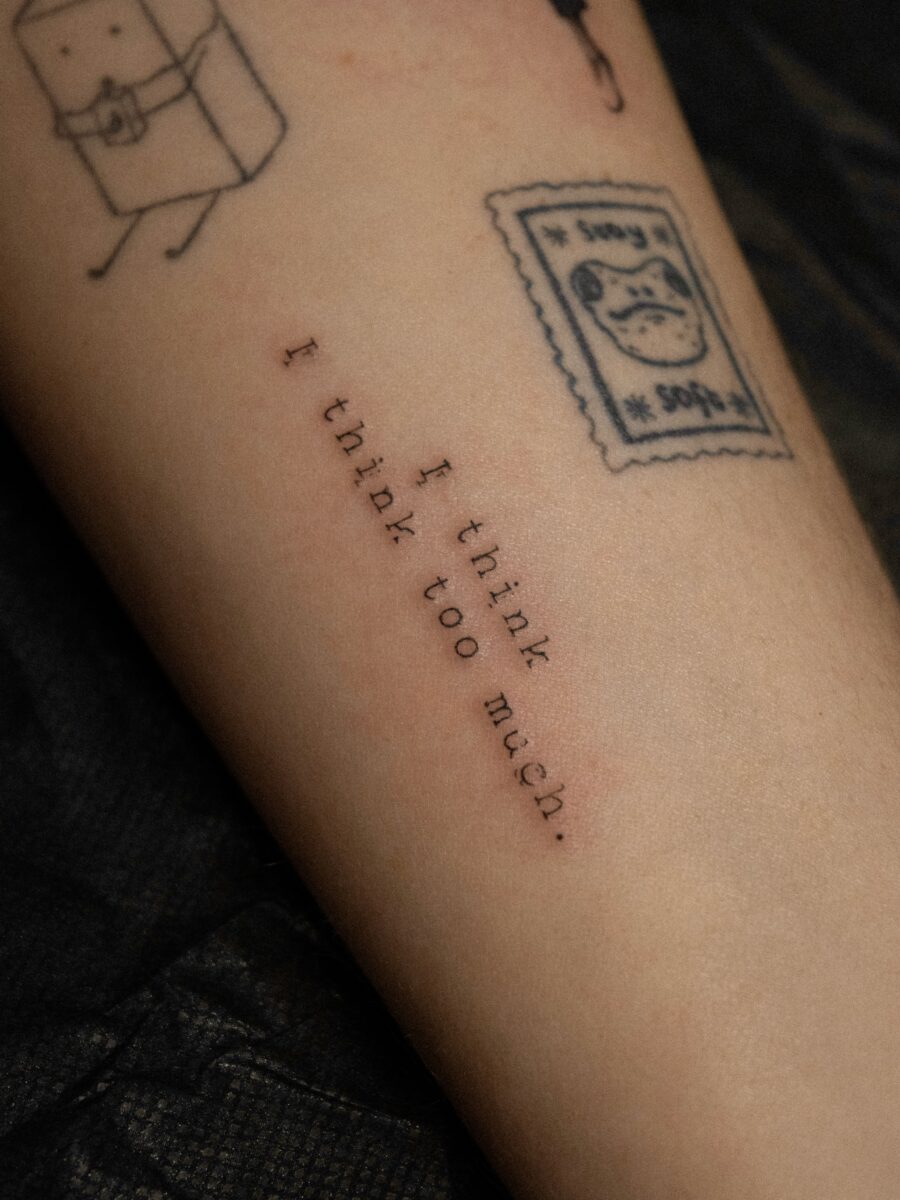 Elegant script tattoo showcasing thoughtful expression