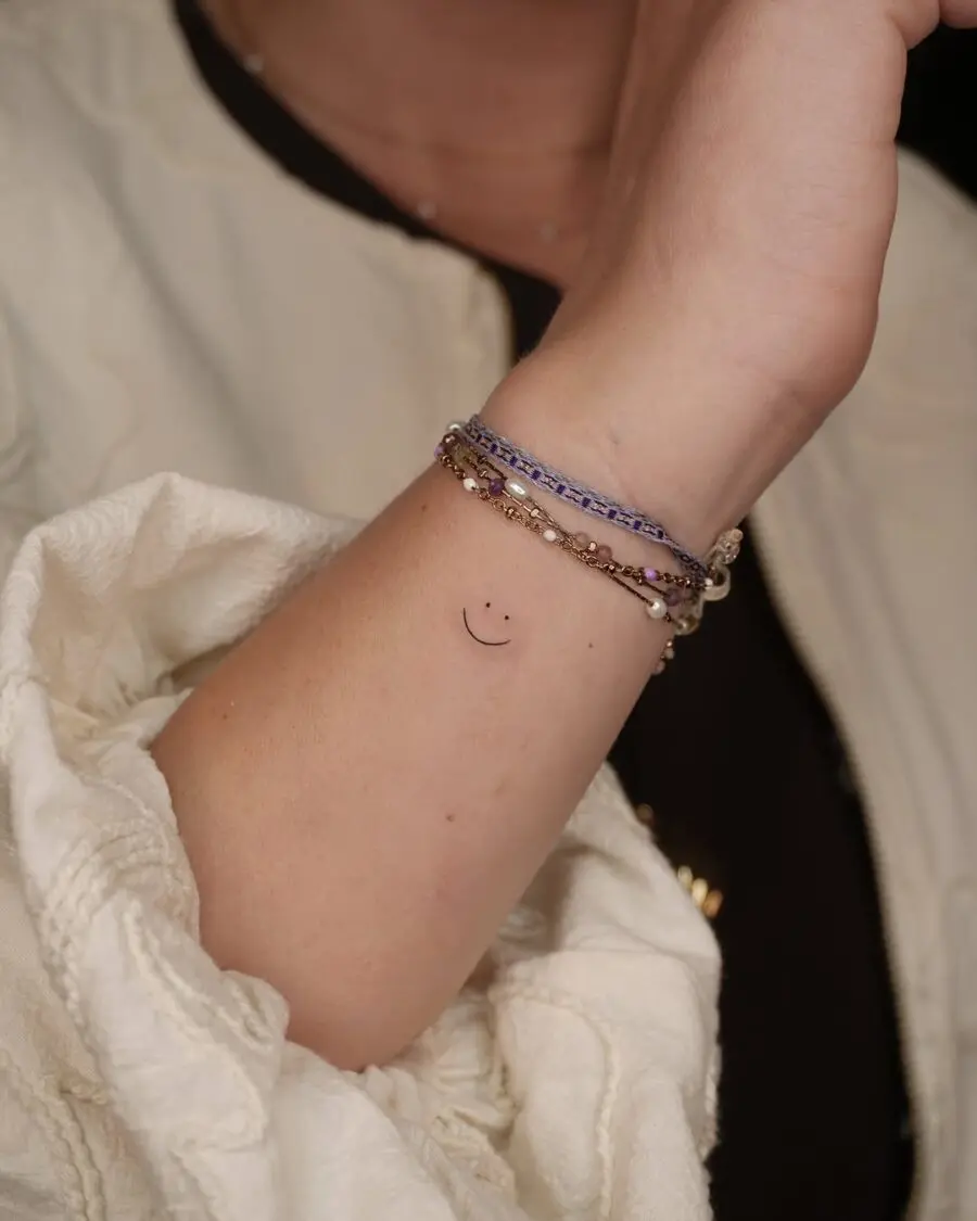 Charming minimalist smiley face tattoo design