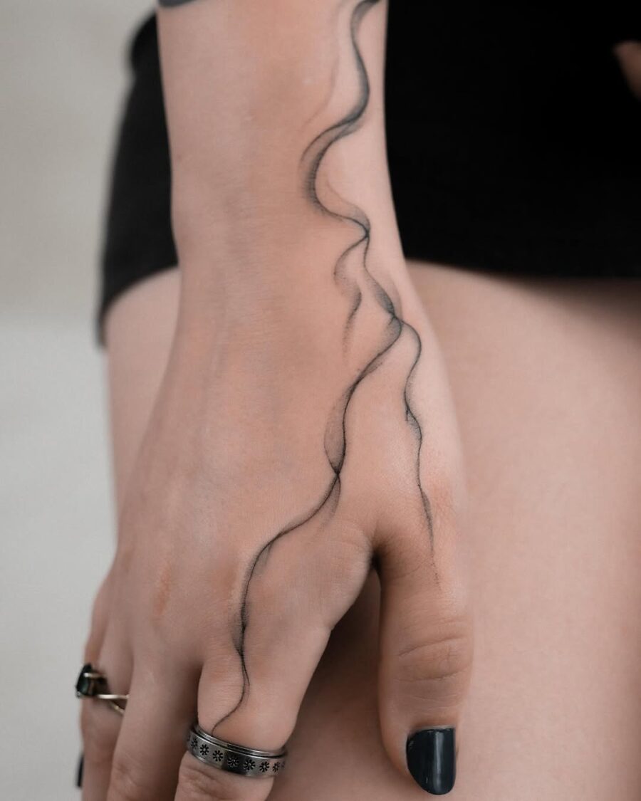 Elegant wave tattoo design on hand