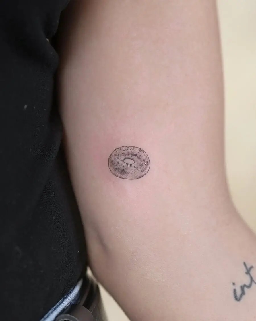 Charming minimalist bagel tattoo on the arm