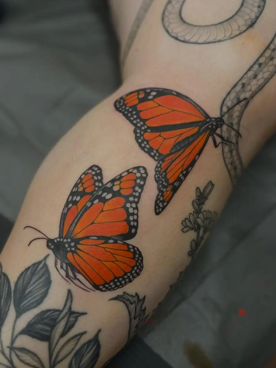Vibrant orange butterfly tattoos for bold expressions