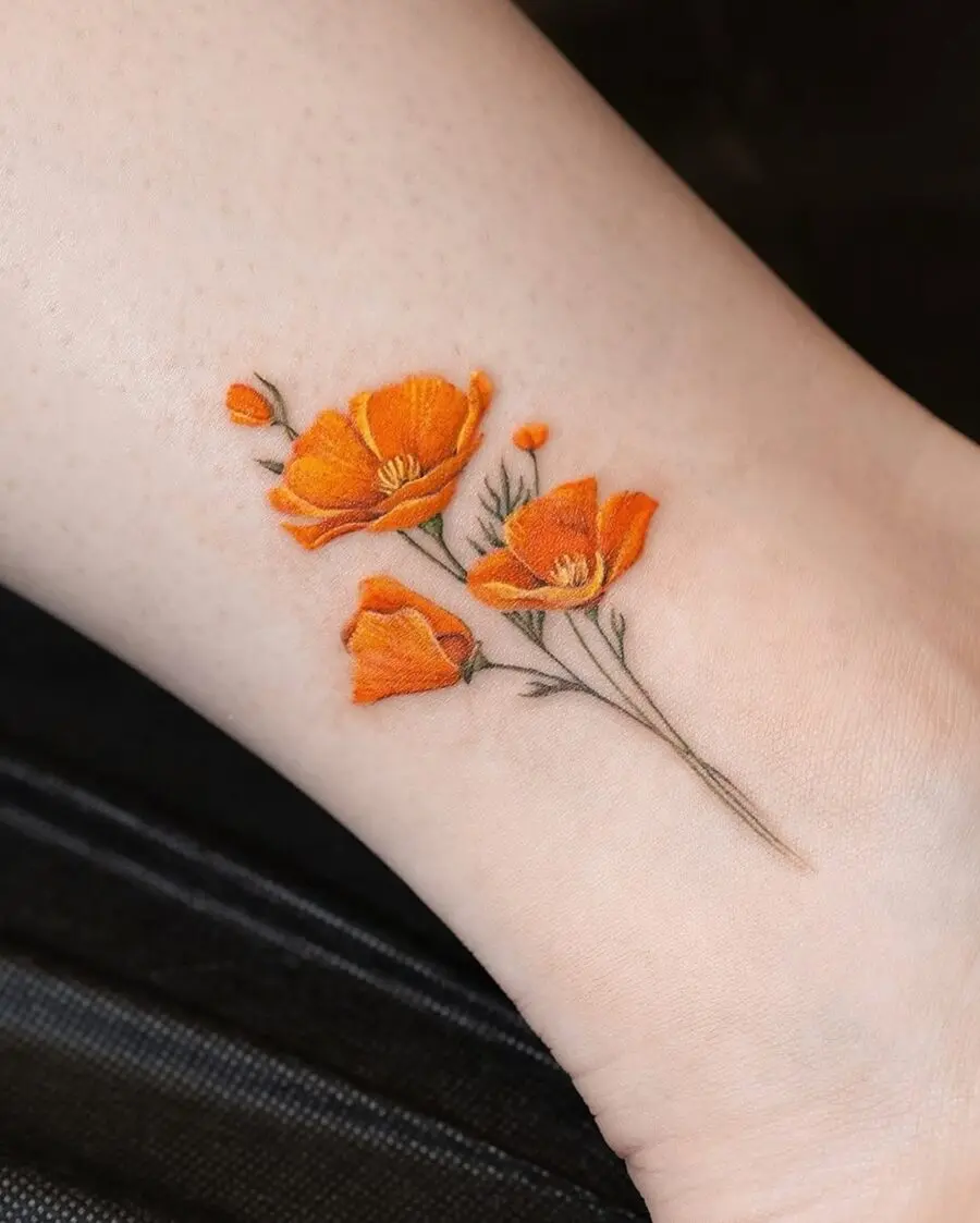Charming orange floral tattoo on the ankle