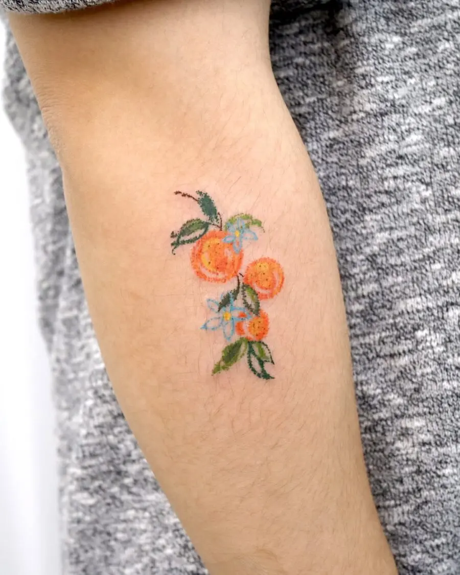 Vibrant orange fruit tattoo with floral accents