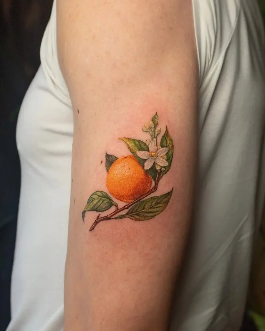 Vibrant orange tattoo with delicate flowers